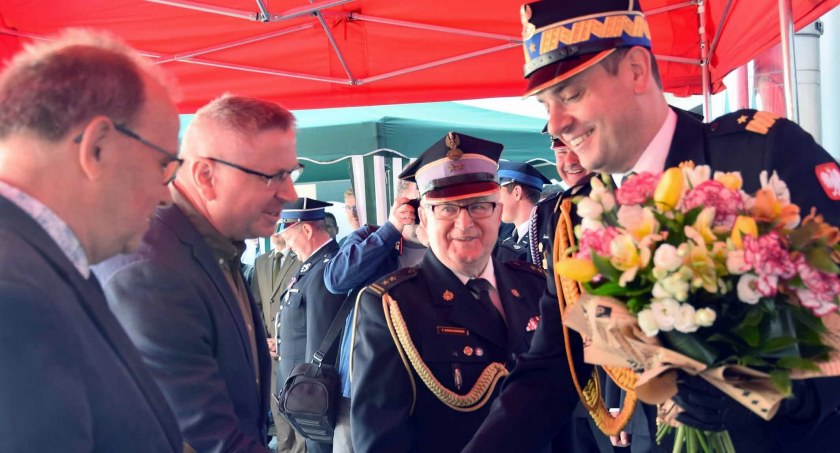 Zdjęcie generała Krzysztofa Cioska, który odbiera kwiaty od druhów strażaków